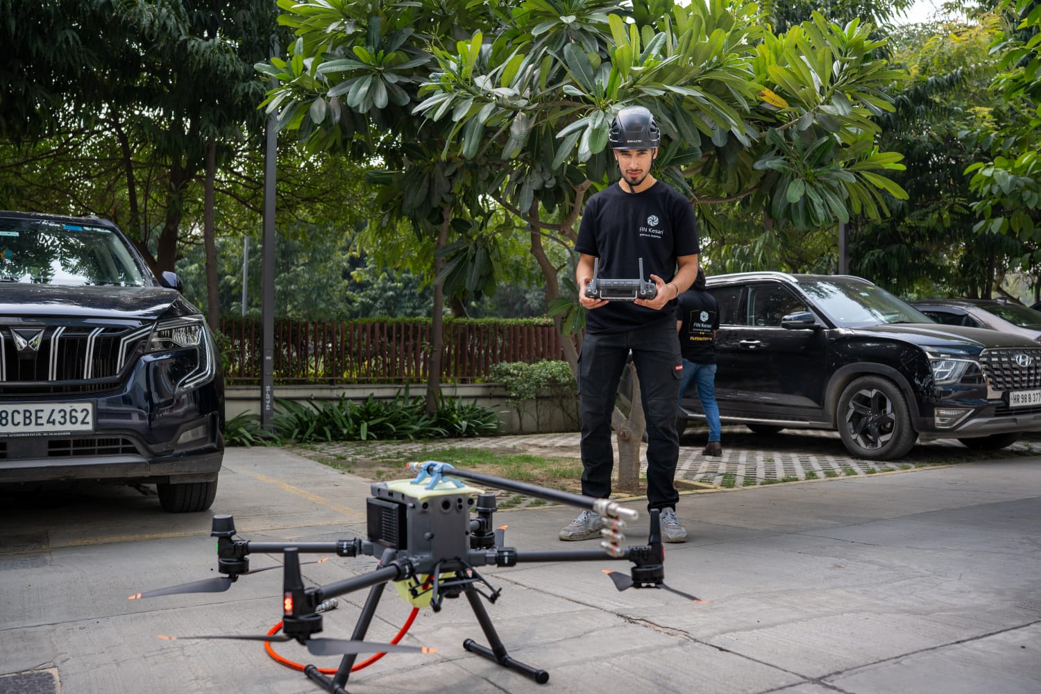 Fin Kesari pilot preparing the Aero-Wash® drone on-site